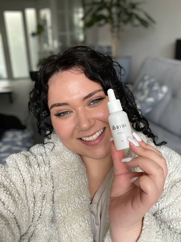 Smiling woman holding Vital Roots product