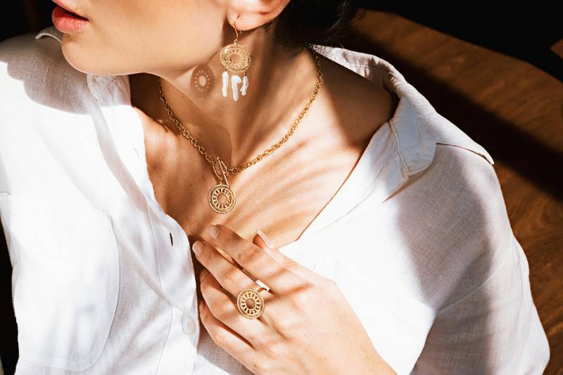 Model wearing Solstice collection jewelry in the sunlight