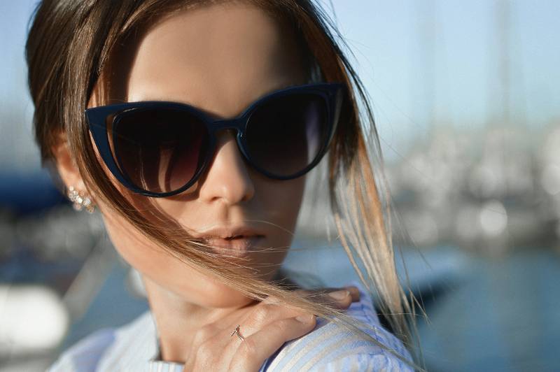Woman wearing Coast sunglasses