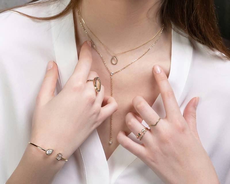 Layered 14k gold necklaces and rings